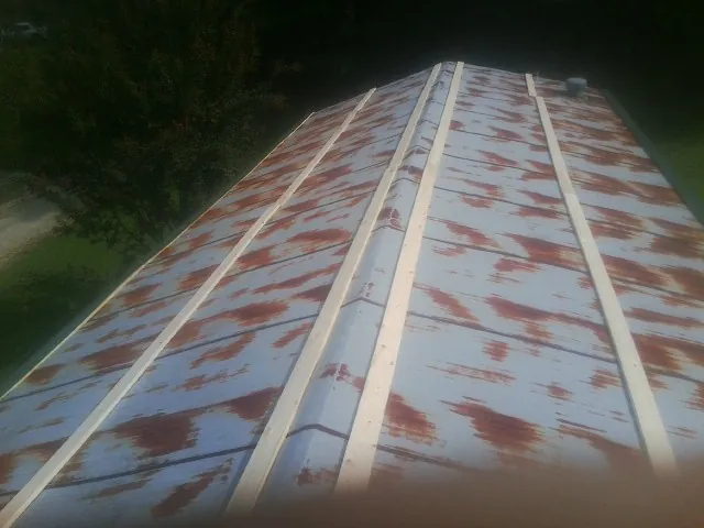 Rusted metal roof panels with new wood purlins before replacement — Storm Damage Roof Repair in Salida by Roofing Brothers